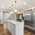 Beautifully designed kitchen featuring a professional gas range, large island workspace, and seamless connection to dining areas.