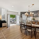 Sophisticated dining space accented by a statement chandelier, wood floors, and natural light for formal or casual meals.