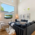 Bright great room featuring expansive windows, high ceilings, and an open floor plan perfect for entertaining and everyday comfort.