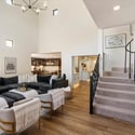 Beautifully designed great room highlighting architectural character, staircase views, and seamless flow to nearby living areas.