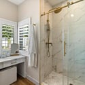 Spa-style walk-in shower with floor-to-ceiling tile, refined hardware, and glass enclosure creating a luxurious daily escape.