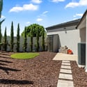 Private side yard with turf area, clean landscaping, and added storage offering flexible outdoor functionality and privacy.
