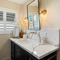 Updated guest bathroom showcasing quartz counters, sleek hardware, and clean-lined cabinetry for a polished, move-in-ready feel.