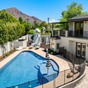 Fenced pool area offering safety, privacy, and open yard space, complemented by well-maintained landscaping.