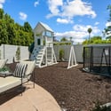 Private backyard play space with custom equipment, clean landscaping, and room to enjoy outdoor living year-round.