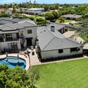 Aerial view highlighting the balance of lawn, pool, and outdoor living spaces within this expansive Phoenix backyard.