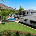 Overhead view emphasizing the pool design, lawn areas, and seamless layout of the backyard and home.