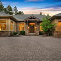 Large paver motor court with extensive guest parking, custom garage spaces, and refined mountain architecture designed for upscale living in Flagstaff.