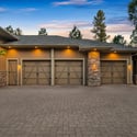 Custom temperature-controlled garage with room for five vehicles, golf cart storage, workshop space, and high-end convenience features throughout.
