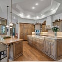 Stunning chef s kitchen with double islands, premium finishes, custom cabinetry, and spacious open-concept design perfect for entertaining and daily living.