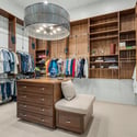 Expansive custom closet with built-in shelving, center storage island, designer lighting, and boutique-inspired organization designed for upscale everyday living.