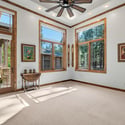 Bright bedroom with soaring ceilings, expansive windows, and clean modern finishes creating a peaceful and comfortable mountain living environment.