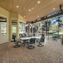 Beautiful outdoor entertaining space with expansive patio seating, covered gathering areas, and peaceful forest surroundings in luxury Flagstaff living.