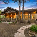 Luxury estate positioned on over an acre of beautifully landscaped property surrounded by mature pines, offering exceptional privacy and outdoor living space.