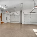 Expansive five-car garage with clean finishes, oversized parking areas, and durable epoxy floors perfect for vehicles and storage needs.