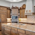 Stunning gourmet kitchen with custom cabinetry, oversized island, double ovens, and luxury finishes perfect for entertaining and upscale mountain living in Flagstaff.