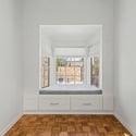 Cozy built-in window seat framed by large windows that bring in natural light and courtyard views. This versatile area can serve as a breakfast nook, reading corner, or relaxing retreat.