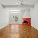 Bright and open living room with vaulted ceilings, architectural details, and warm wood flooring. The flexible layout offers endless possibilities for furnishing and entertaining.