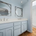 Spacious vanity area with dual sinks, generous countertop space, and stylish mirrors. Designed for convenience, this area supports a functional and organized daily routine.