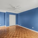 Secondary bedroom offering excellent versatility for guests, remote work, fitness equipment, or hobbies. Natural light and ceiling fan comfort enhance the space.