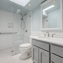 Updated bathroom featuring a sleek walk-in shower with subway tile walls, glass enclosure, and modern finishes. The stylish design creates a clean and refreshed look.