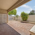 Shaded patio featuring attractive paver finishes and privacy-enhancing walls. This comfortable outdoor space is ideal for entertaining guests or enjoying quiet mornings outdoors.