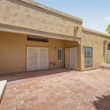 Private courtyard with durable paver flooring, mature landscaping, and ample room for outdoor furnishings. The low-maintenance design encourages year-round outdoor enjoyment.
