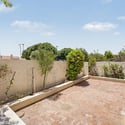 Large paver courtyard framed by mature landscaping and privacy walls. This inviting outdoor setting provides an excellent extension of the home's living and entertaining space.
