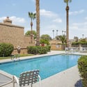 Well-maintained community pool surrounded by lush landscaping, lounge seating, and sunny gathering areas. A standout feature that adds comfort and convenience to everyday Scottsdale living.