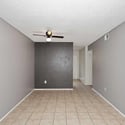 Open dining area with neutral finishes and tile flooring provides the perfect space for casual meals, entertaining, or a home office setup. The layout enhances the home's spacious feel.