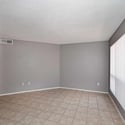 Large great room with clean lines, neutral d cor, and tile flooring throughout. The flexible floor plan accommodates a variety of furniture arrangements and lifestyle needs.