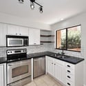 Updated kitchen featuring stainless steel appliances, subway tile backsplash, refreshed cabinetry, and abundant workspace. Designed to blend style, storage, and functionality for daily living.