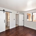 Spacious primary suite offering updated flooring, neutral tones, and convenient access to the ensuite bathroom. A comfortable and inviting space designed for relaxation.