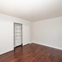 Generous primary bedroom featuring rich flooring, natural light, and a versatile layout. The updated finishes create a comfortable retreat within this Glendale home.