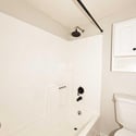 Bright bathroom featuring a tub and shower combination with updated fixtures and easy-care finishes. A clean, comfortable space designed for daily convenience.