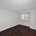 Secondary bedroom with updated flooring, neutral finishes, and a comfortable layout. Perfect for guests, a home office, workout room, or hobby space.