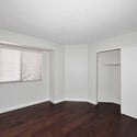 Bright guest bedroom featuring generous closet space, natural light, and attractive flooring. This versatile room offers comfort and flexibility for a variety of lifestyle needs.