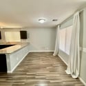Bright dining space conveniently connected to the kitchen and living areas. Large windows and an open layout create an inviting atmosphere for meals and entertaining.