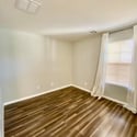 Spacious primary bedroom with plush carpeting, ceiling fan, and calming neutral tones. A peaceful retreat designed for comfort and everyday relaxation.