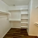 Walk-in closet featuring extensive shelving, hanging space, and room for seasonal storage. An excellent feature that adds organization and value to this Surprise home.