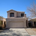 Beautiful Glendale home featuring a private driveway, attached 2-car garage, and classic tile roof architecture. Situated within a gated community offering a community pool and convenient access to local amenities.