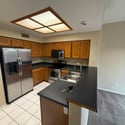 Open kitchen design with stainless steel appliances, breakfast bar seating, and easy access to the surrounding living spaces. Ideal for both entertaining and everyday use.