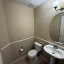 Convenient guest bathroom with pedestal sink, tile flooring, and neutral d cor. Ideally positioned to serve visitors while maintaining privacy for the main living areas.