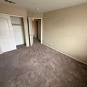 Well-sized bedroom featuring neutral finishes, soft carpeting, and a spacious closet. Designed to provide comfort and functionality for everyday living.