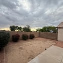 Enjoy a generously sized backyard with desert landscaping, flowering shrubs, and privacy fencing. This versatile outdoor space offers endless possibilities for gardening, recreation, or future outdoor enhancements.