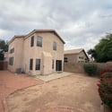 Exterior rear view highlighting the home's private backyard, concrete patio, and low-maintenance landscaping. Designed for easy outdoor living, this space offers privacy, functionality, and room to enjoy Glendale's outdoor lifestyle.