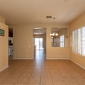 Generous living room with tile flooring and plantation shutters throughout. This versatile area offers endless possibilities for formal entertaining, a sitting room, or additional family gathering space.
