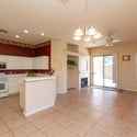 Open kitchen overlooking the family room with breakfast bar seating, abundant storage, and recessed lighting. The seamless design encourages conversation and connection while entertaining.