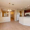 Well-appointed kitchen with abundant cabinetry, breakfast bar, tile counters, and convenient workspace. The open design keeps the kitchen connected to the home's main living spaces.