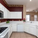 Spacious kitchen with wraparound counters, built-in appliances, and views into the living areas. A functional space that blends convenience with an open-concept floor plan.
